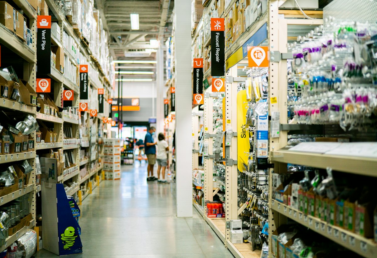 A store aisle stocked with household and hardware products